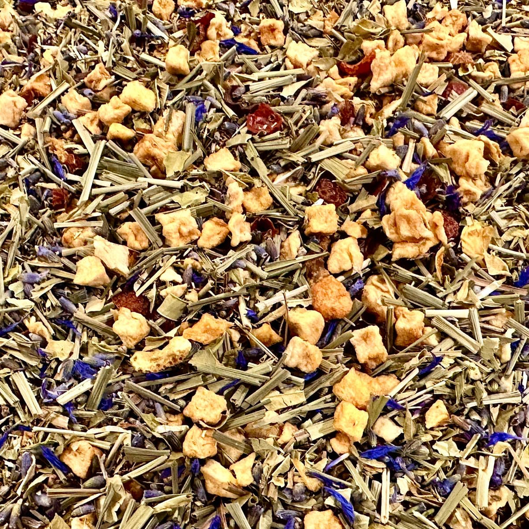 Assorted herbal tea leaves including lavender, lemon peel, lemon grass, rooibos, and other botanicals.