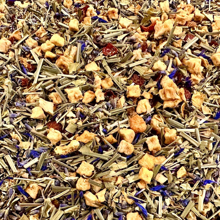 Assorted herbal tea leaves including lavender, lemon peel, lemon grass, rooibos, and other botanicals.