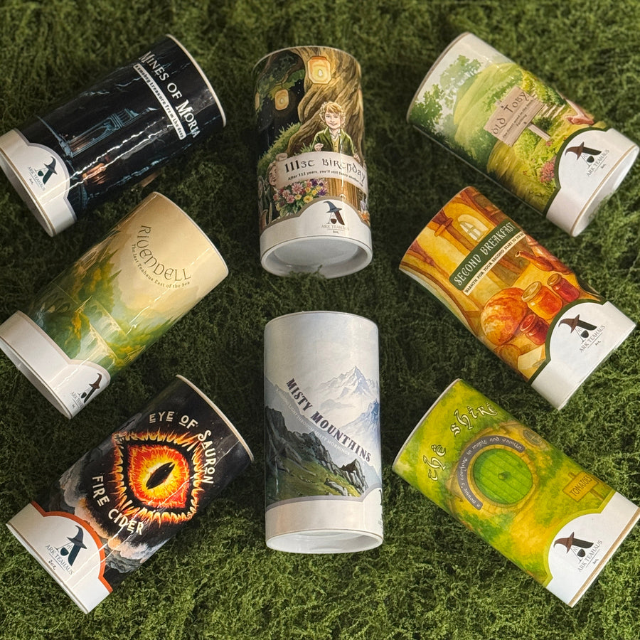 A set of all 8 middle earth themed teas in tins on moss