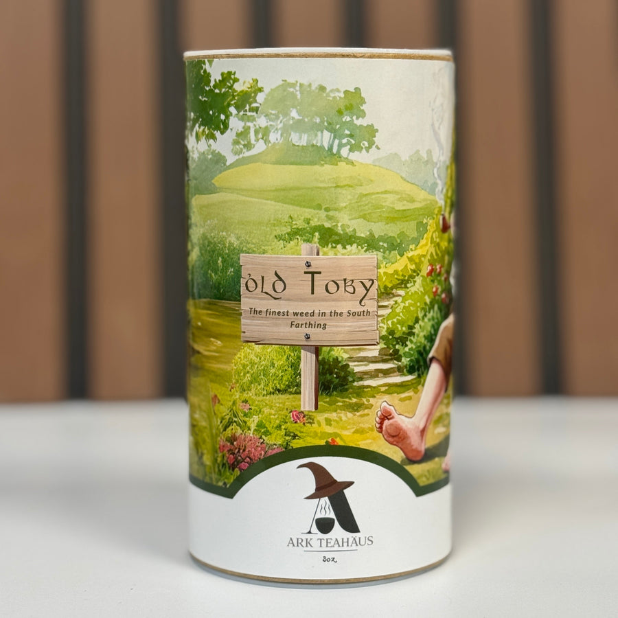Tea canister with scenic design and 'Old Toby' branding on a neutral background